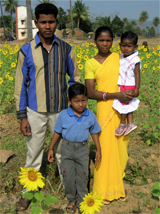 Sora consultant Mr. Rowo Gamango and family
		among sunflowers
